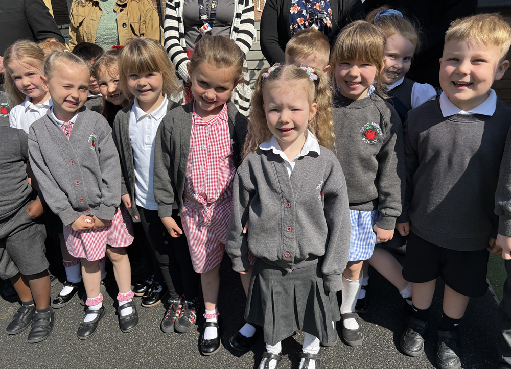 Isaac EYFS pupils smiling in the sunshine